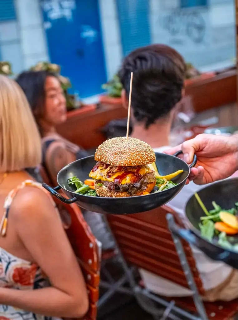 Group of friends enjoying burgers together at Let's Be Frank
